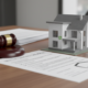 MEES regulations compliance - gavel and model house representing landlord legal requirements