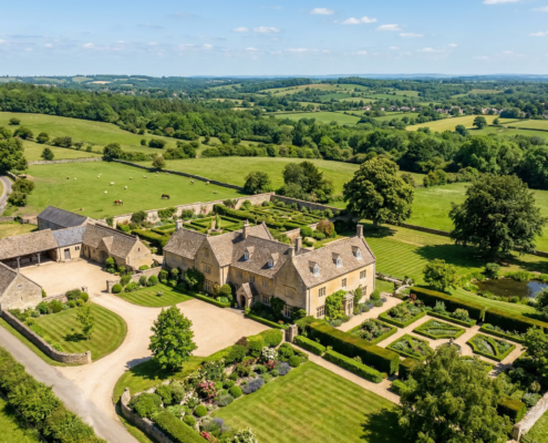 Aerial drone photograph of a rural English countryside estate with stone farmhouse and gardens
