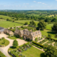 Aerial drone photograph of a rural English countryside estate with stone farmhouse and gardens