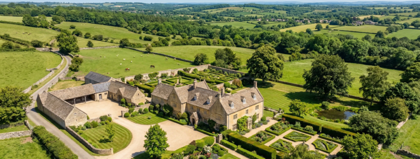 Aerial drone photograph of a rural English countryside estate with stone farmhouse and gardens