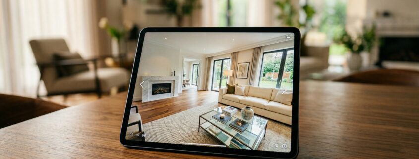 Tablet displaying a 3D virtual tour of a property living room, representing virtual tour technology for estate agents
