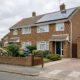 Typical 1970s British semi-detached house with solar panels on the roof, representing EPC energy efficiency upgrades for Oxfordshire landlords