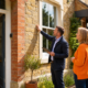 Energy assessor reviewing an Oxfordshire rental property's exterior with a landlord